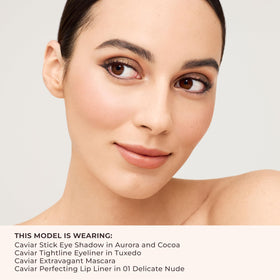 Laura Mercier held in hand to show size and travel convenience