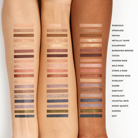 Laura Mercier stick next to hand showing travel-friendly size benefit