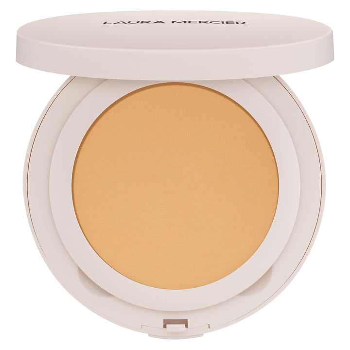 Laura Mercier compact front view showing sleek packaging and portability benefit