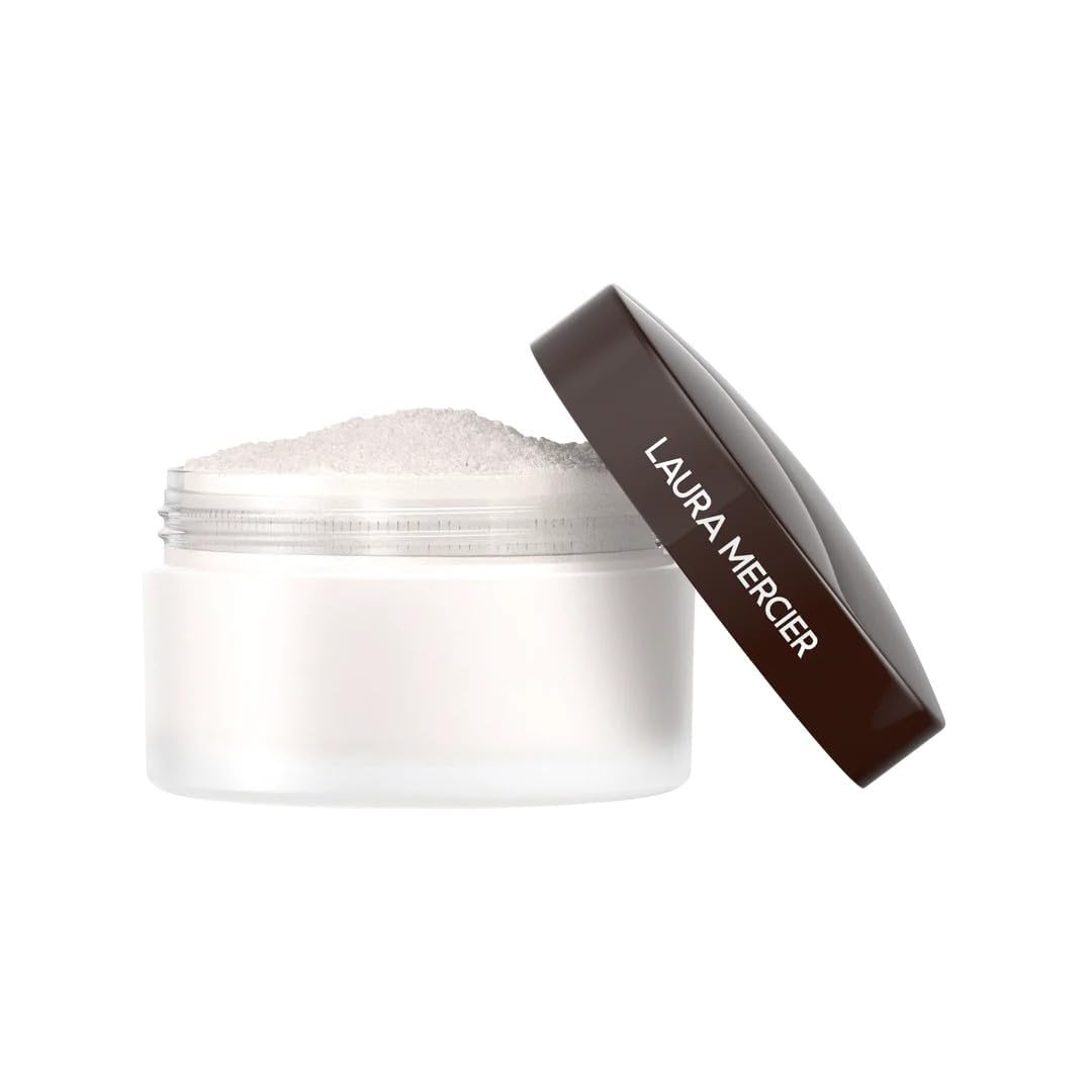 Laura Mercier compact inside makeup bag near mirror suggesting on-the-go touchups