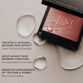 Laura Mercier compact beside coin showing compact size and travel-friendly benefit