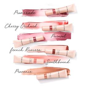 Laura Mercier applied in mirror lifestyle shot showing radiant cheeks and effortless routine