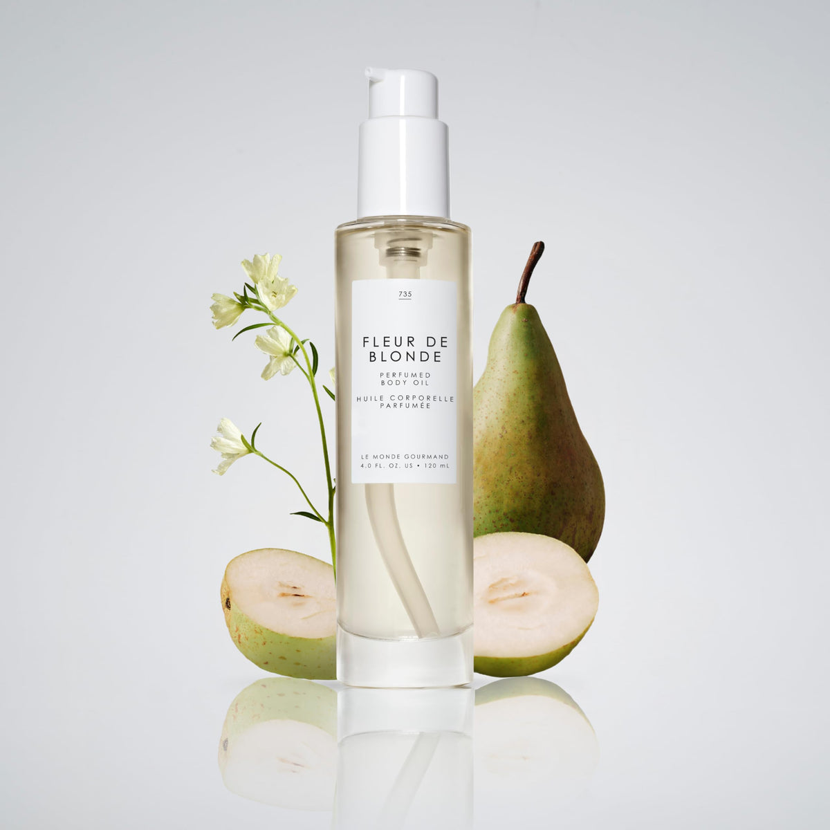 Le Monde Gourmand bottle beside a ruler showing 4 fl oz scale