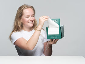 Le Visage towel in hand demonstrating size and easy single-use convenience
