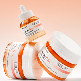 LEADERS ampoule beside moisturizer flatlay, suggests complementary daily use