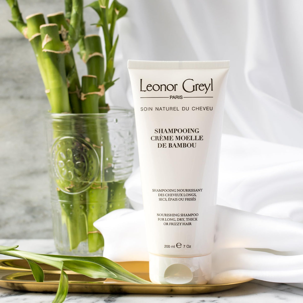 Leonor Greyl ingredient flatlay with bamboo and wheat showing natural benefit