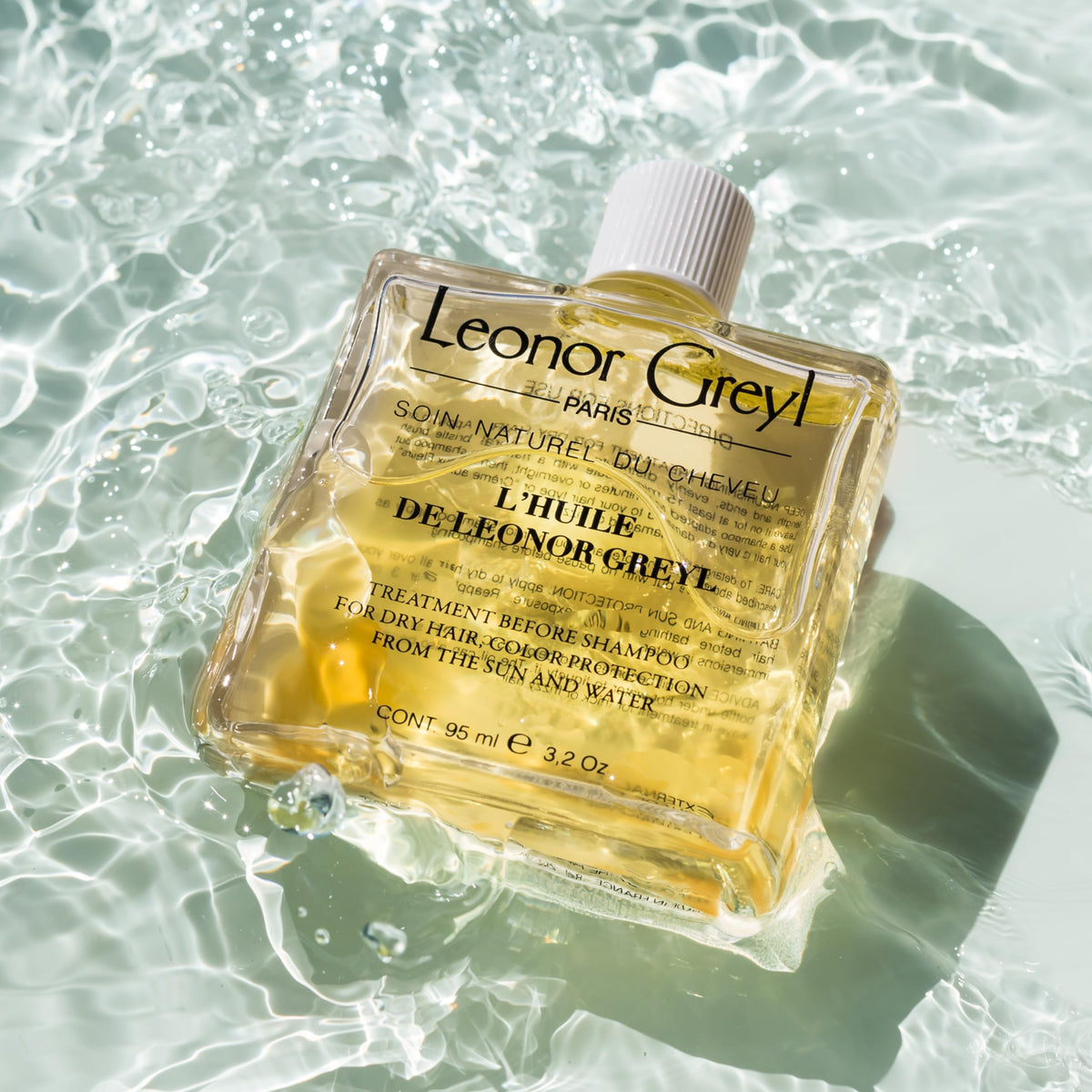 Leonor Greyl oil used poolside to protect hair from chlorine and sun