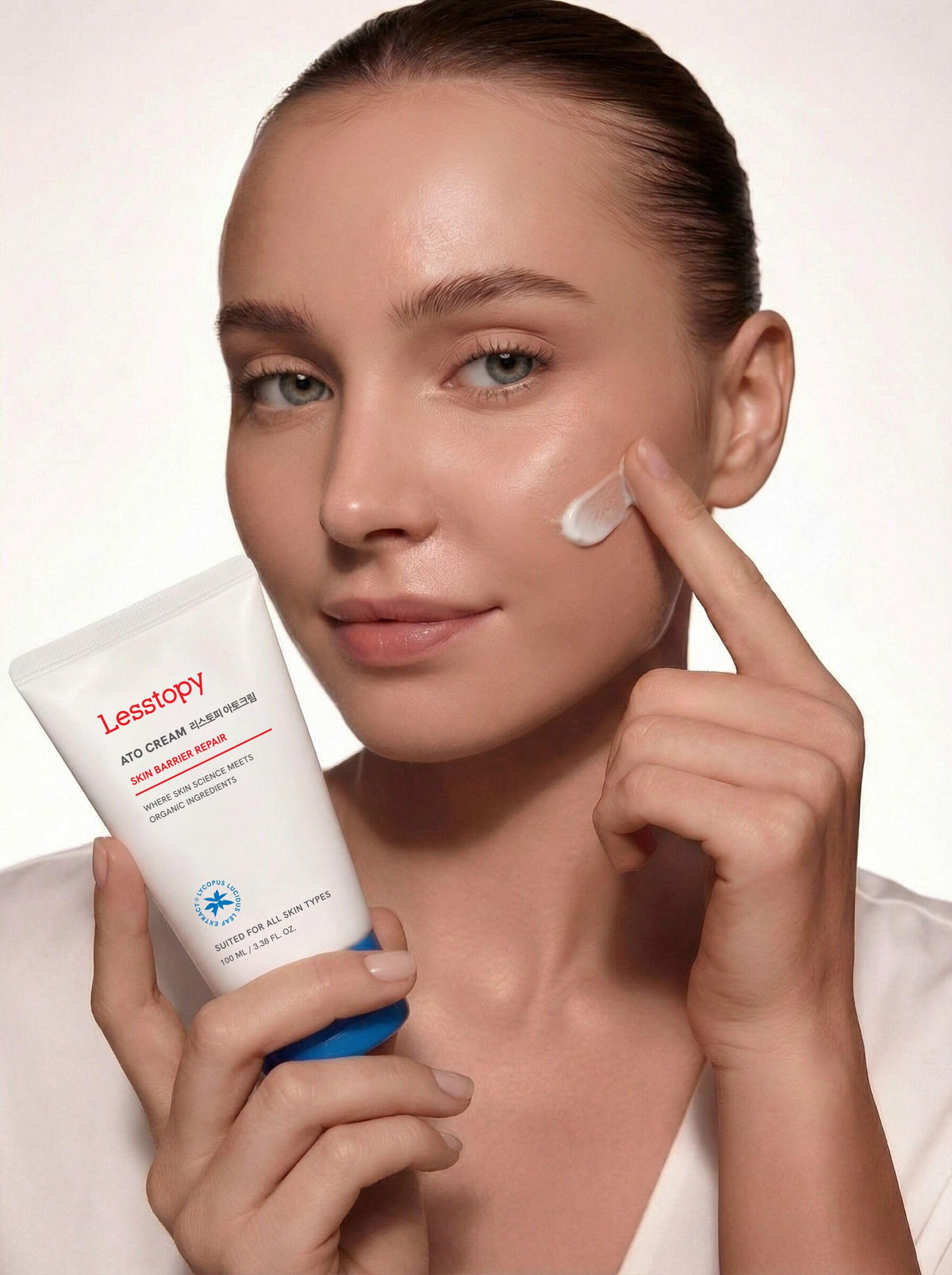 Lesstopy applying cream to a child cheek demonstrating gentle formulation for sensitive skin
