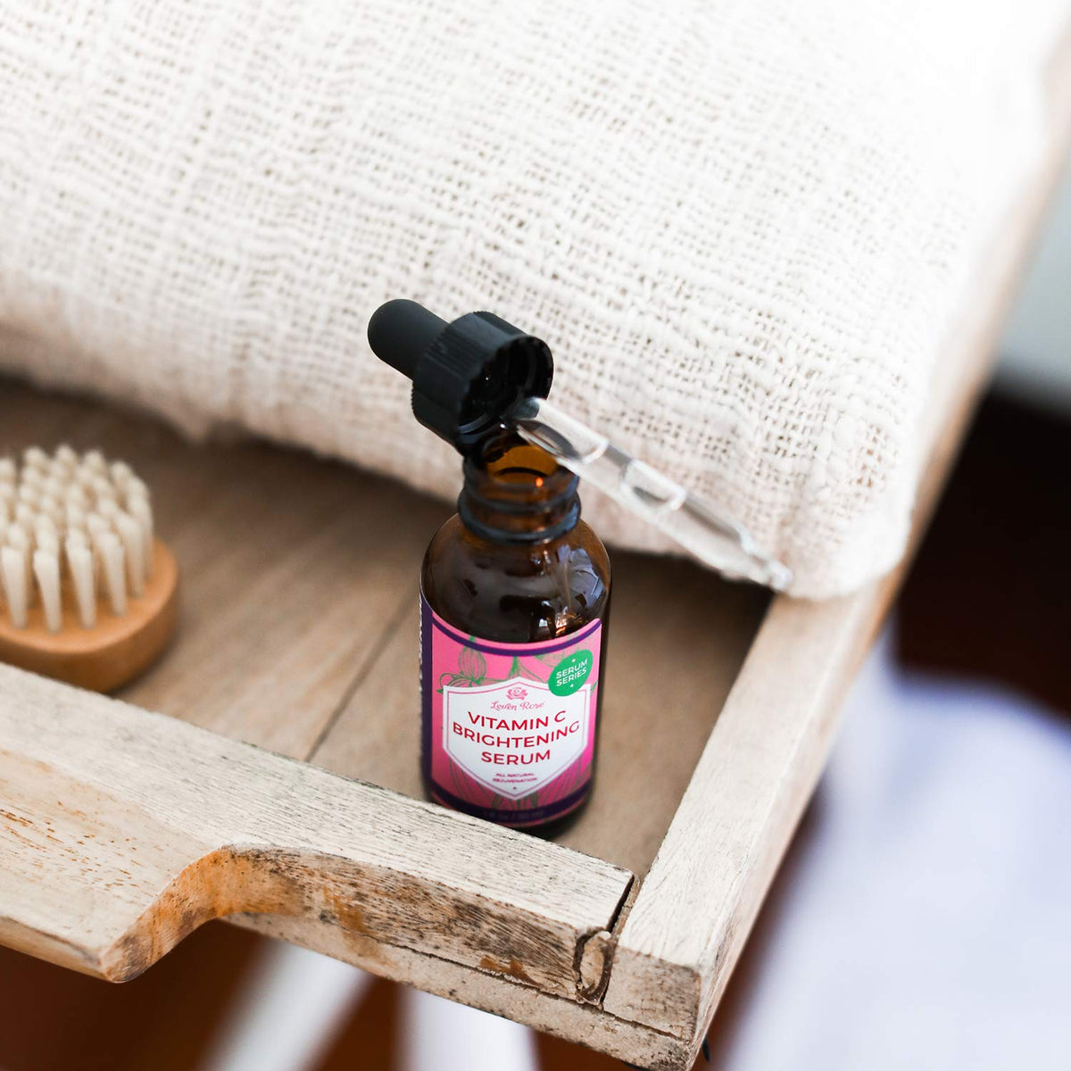Leven Rose bottle beside a coin to show 1 oz size and travel-friendly use