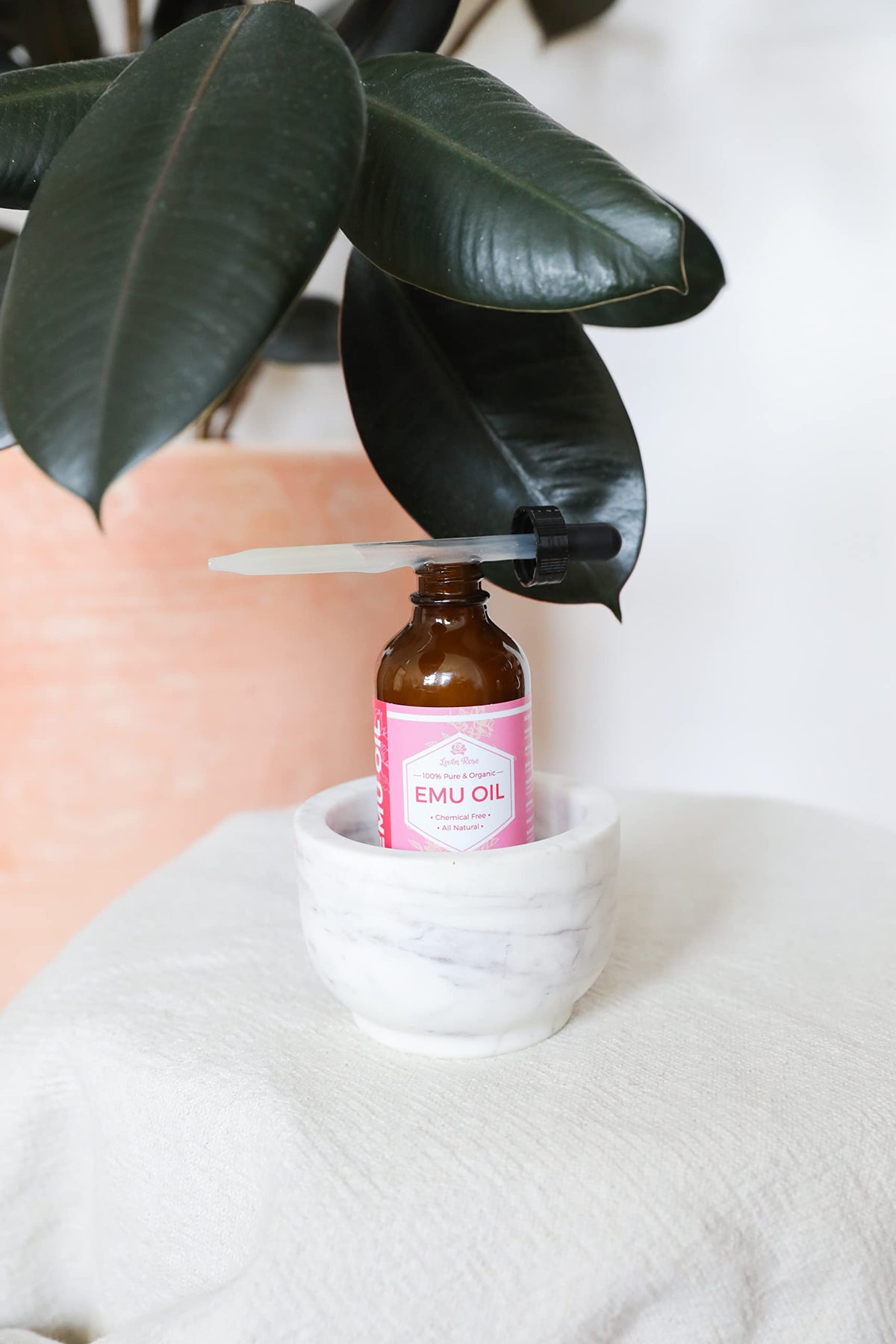 Leven Rose bottle beside common items to show 4 oz size and travel-friendly benefit