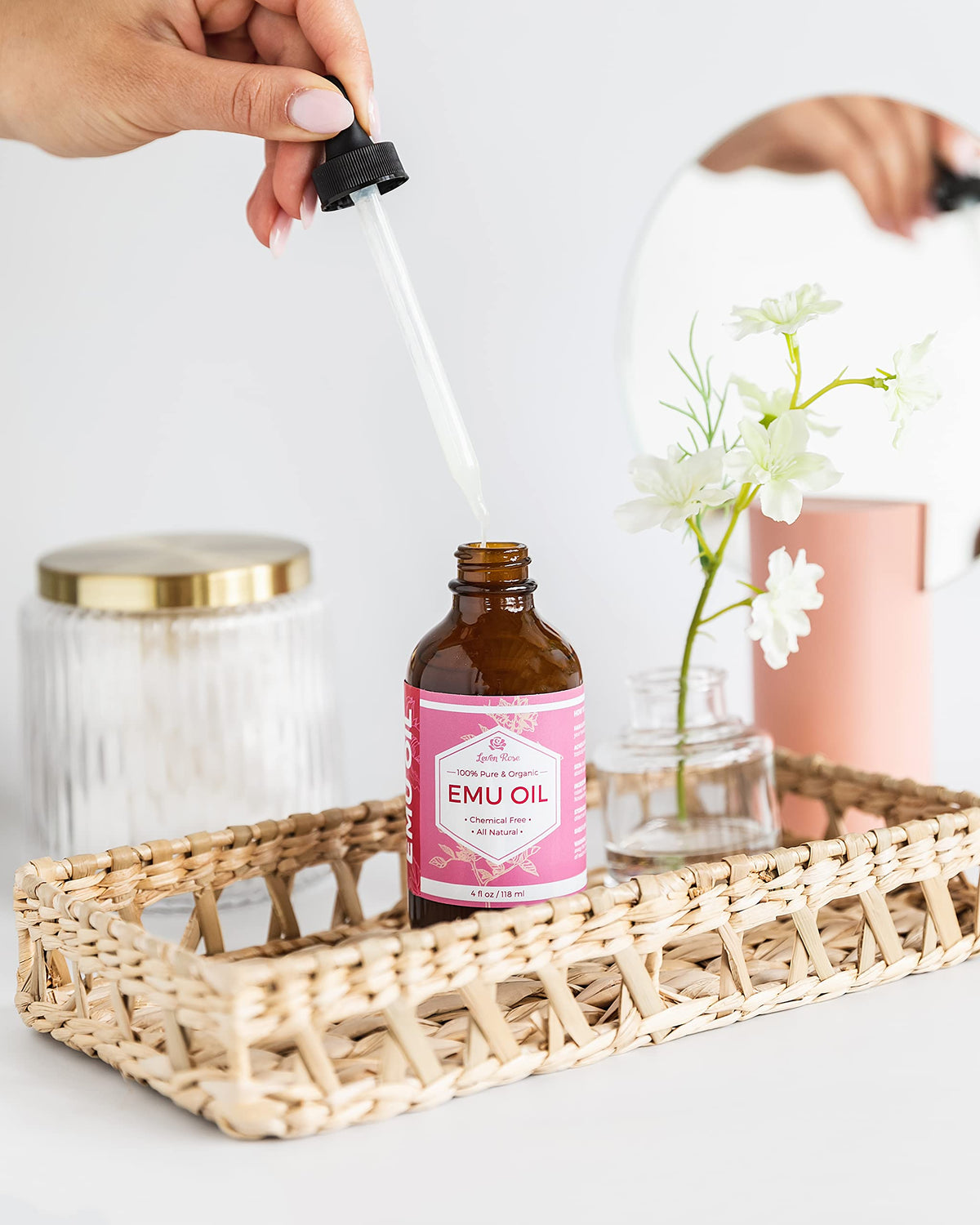 Leven Rose oil texture close-up on fingertip, smooth moisturizing finish benefit
