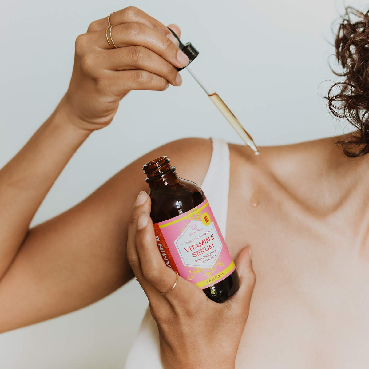 Leven Rose smoothing hair ends illustrating added shine and manageability benefit