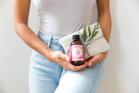Leven Rose 4 oz bottle next to common items illustrating compact travel-friendly size