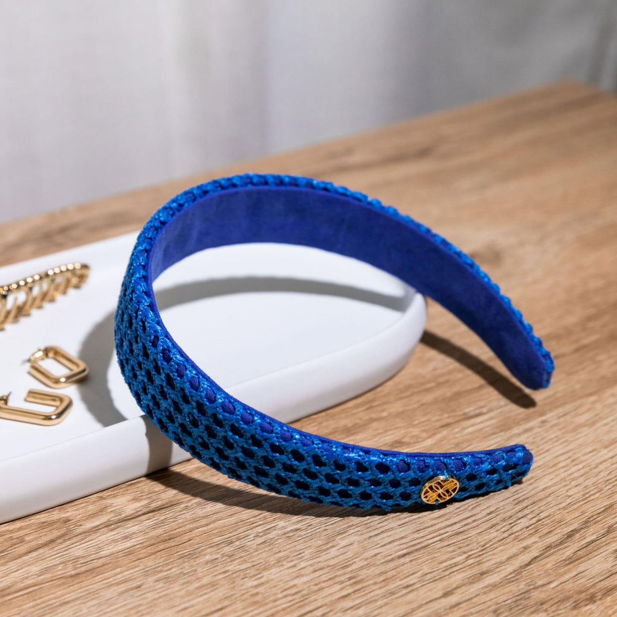 Lilly Pulitzer headband beside common items showing size and fit benefit