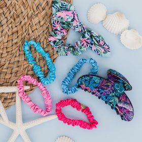 Lilly Pulitzer scrunchies flatlay with outfit pieces showing styling possibilities