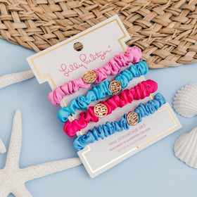 Lilly Pulitzer scrunchies beside a coin for size comparison and compact convenience