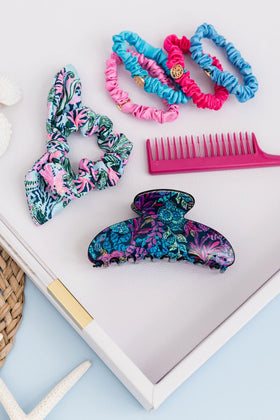 Lilly Pulitzer held in hand to show 4-inch size and ease of use