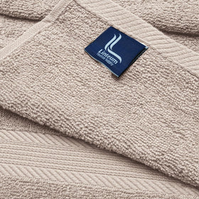 Linteum Textile Supply towel held in hands showing 20x40 inch size for ease