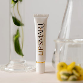 LipSmart next to a coin showing compact travel-friendly product size