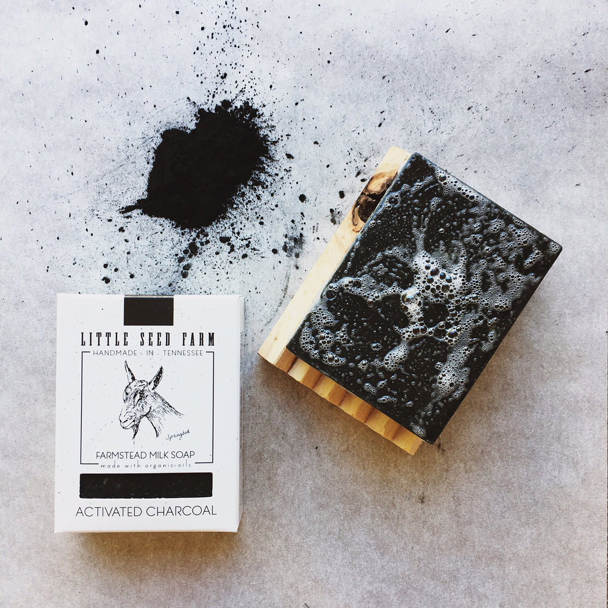 Little Seed Farm soap bar in hand to show 4.75oz size and usability