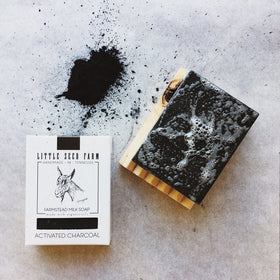 Little Seed Farm soap bar in hand to show 4.75oz size and usability