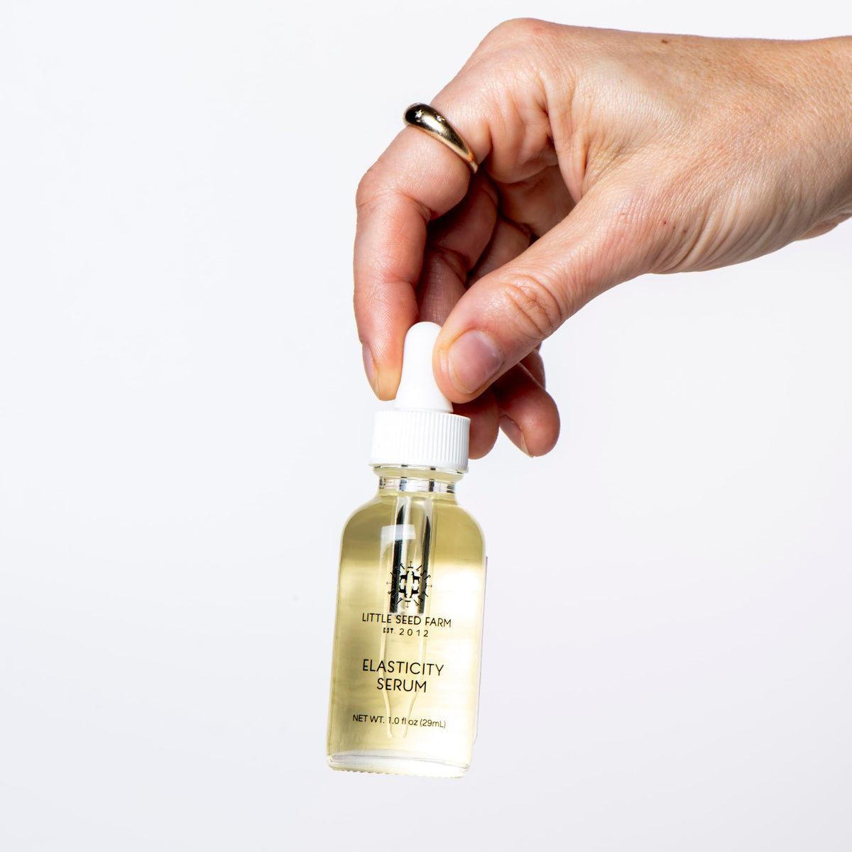 Little Seed Farm applying serum to jawline illustrating easy everyday use