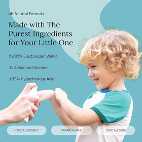 LITTLEY in use parent spraying child hands showing convenient on-the-go cleaning