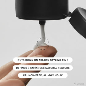 Living Proof in a travel bag among styling tools showing portability benefit
