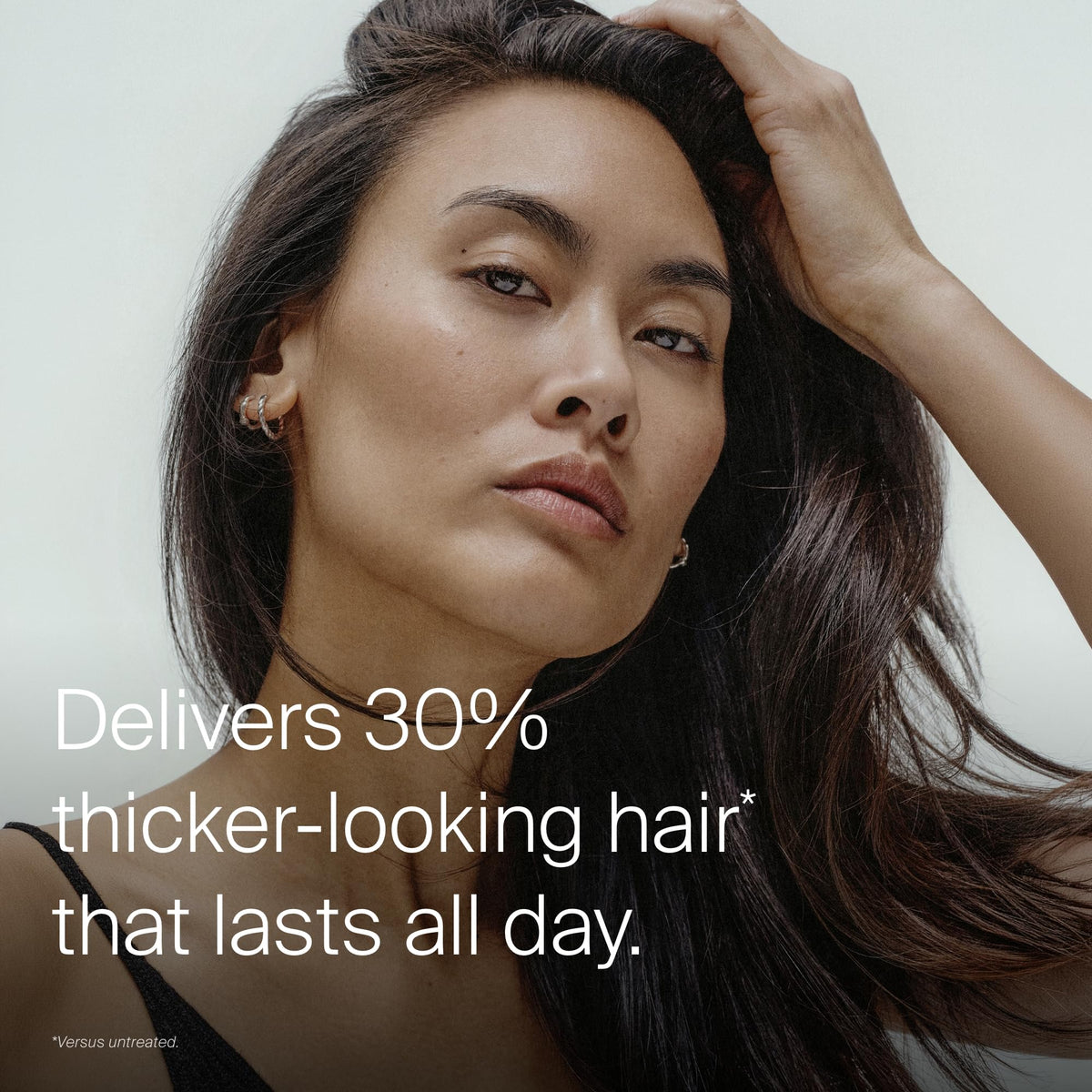 Living Proof applied on towel-dried hair emphasizing easy distribution