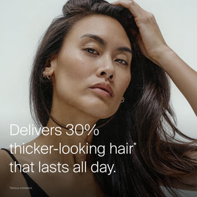 Living Proof applied on towel-dried hair emphasizing easy distribution