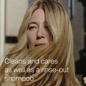 Living Proof spray nozzle close-up showing precise application and even mist