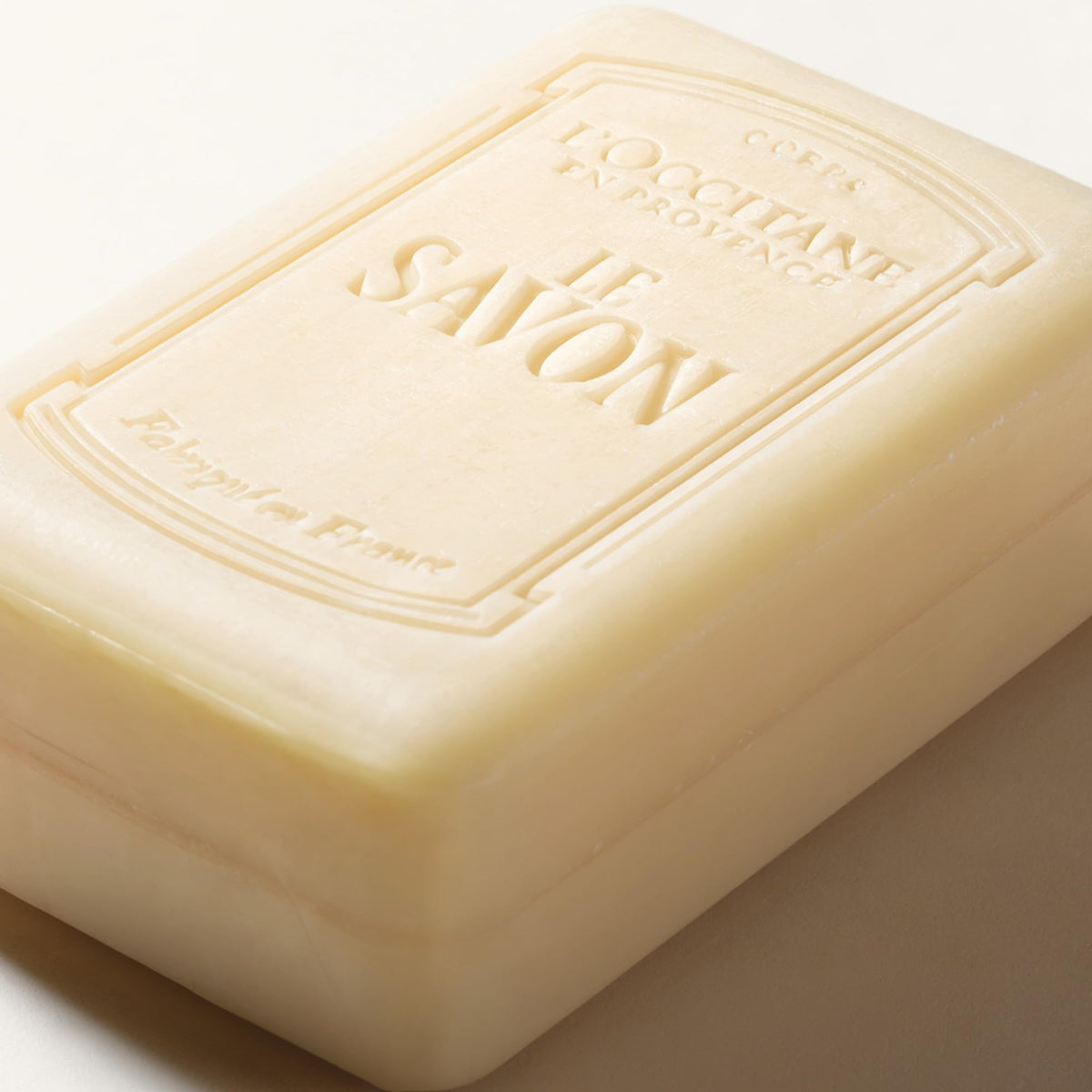 L'OCCITANE soap in bathroom setting, conveys calming lavender ambiance