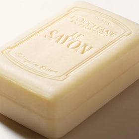 L'OCCITANE soap in bathroom setting, conveys calming lavender ambiance