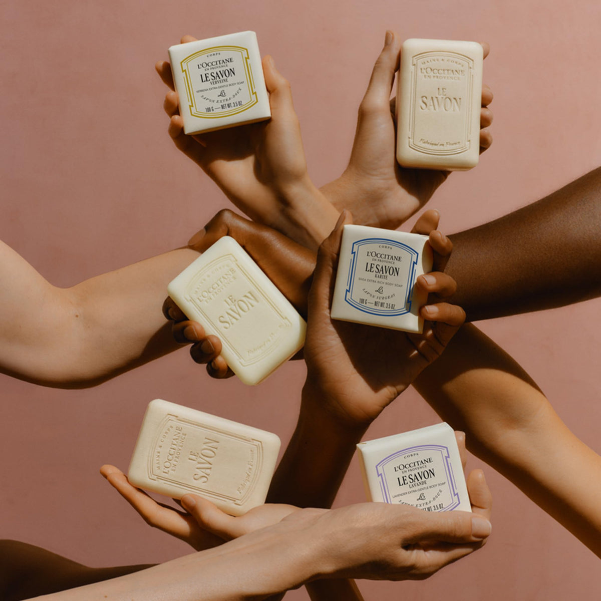 L'OCCITANE soap in hand for scale, shows portable size and travel convenience