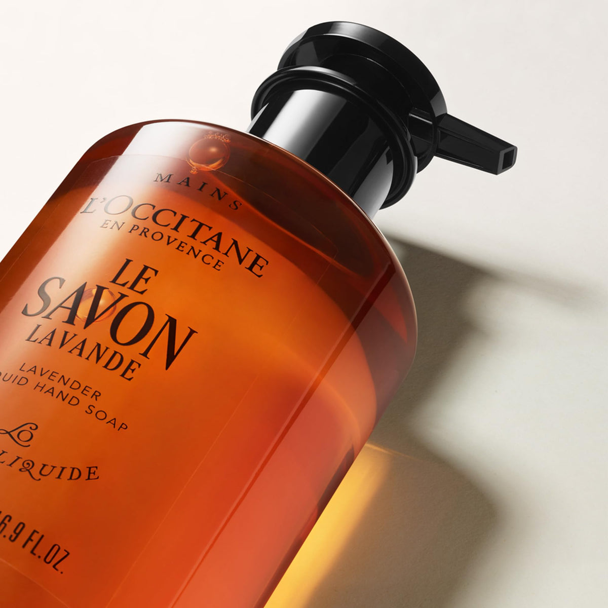 L'OCCITANE bottle on bathroom shelf lifestyle shot evoking Provence routine benefit