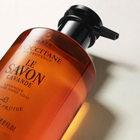 L'OCCITANE bottle on bathroom shelf lifestyle shot evoking Provence routine benefit