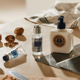 L'Occitane shea wash in shower setting demonstrating gentle cleansing and comforting ritual