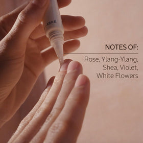 L'Occitane bottle held in hand for scale showing travel-friendly size benefit