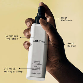 LolaVie mist spraying from bottle demonstrating fine, even application and coverage