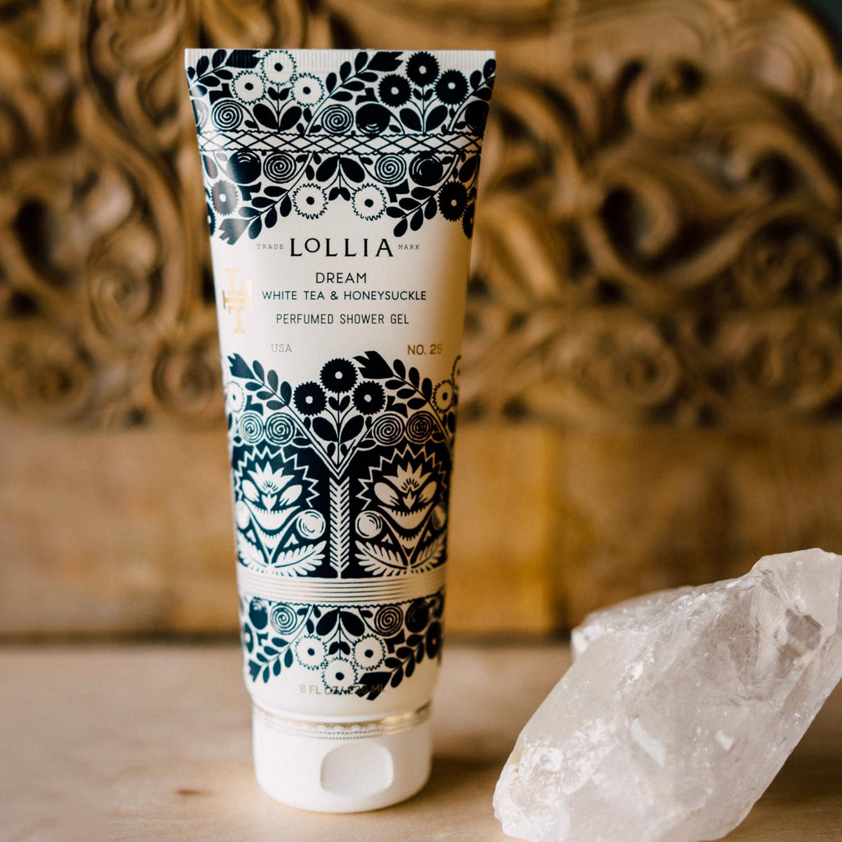 LOLLIA tube held in hand for size comparison and travel-friendly convenience