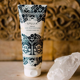 LOLLIA tube held in hand for size comparison and travel-friendly convenience