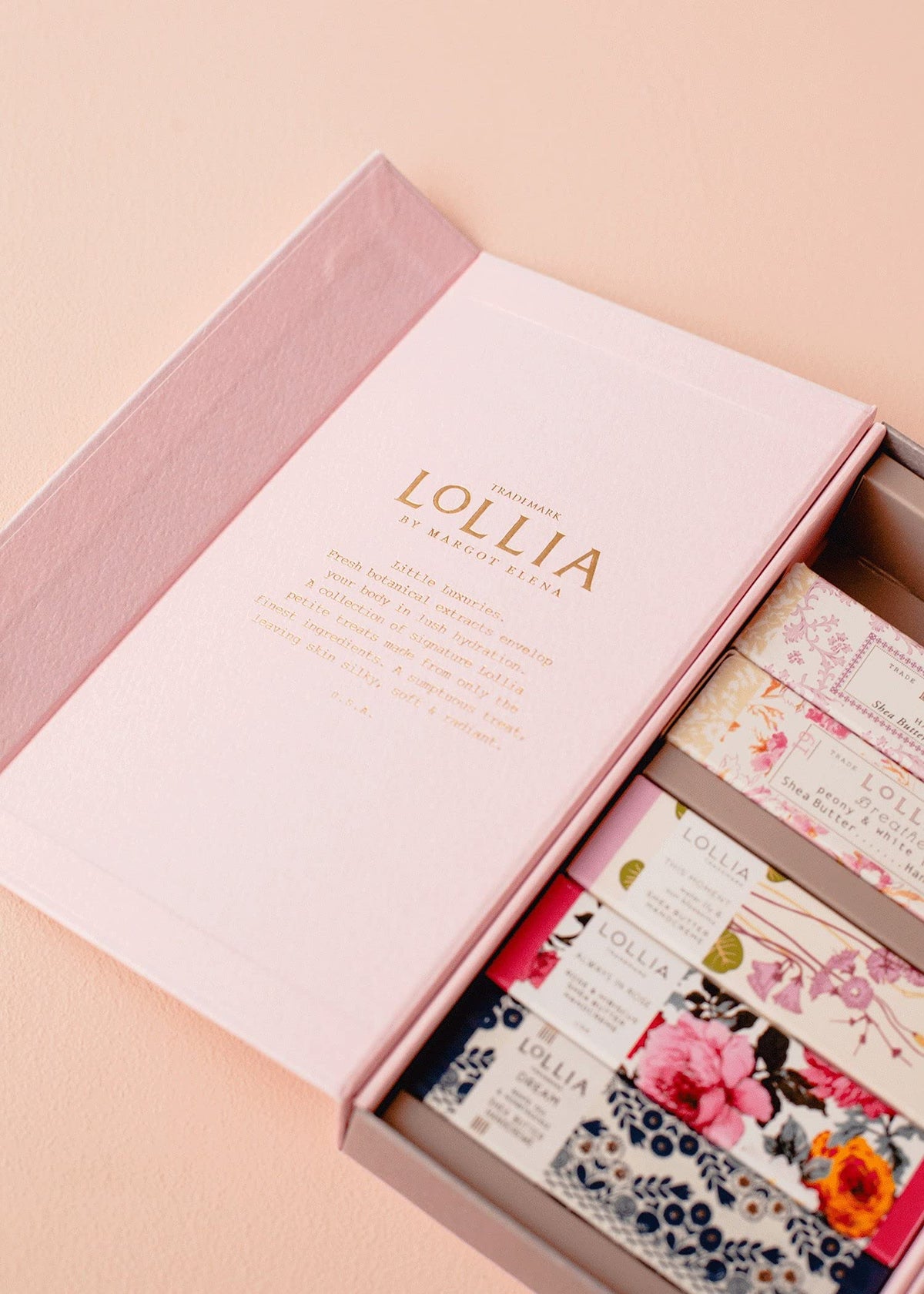 LOLLIA hand holding tube to show scale and portability for purse-ready moisturizing on the go