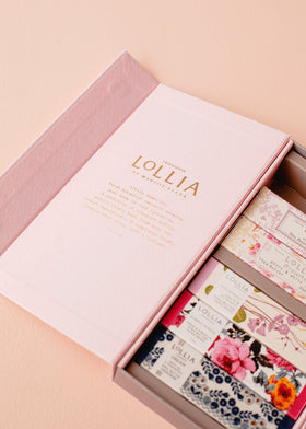 LOLLIA hand holding tube to show scale and portability for purse-ready moisturizing on the go