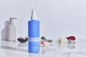 Loma leave-in on bathroom shelf styled to show pear aromatherapy and everyday use