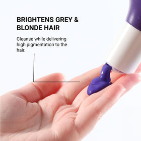 Loma shampoo in shower being applied to blonde hair for quick brassiness control