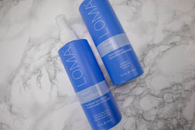 Loma leave-in size comparison in hand highlighting portable 8 oz convenience