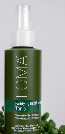 Loma 8 ounce bottle held in hand for scale and portable convenience