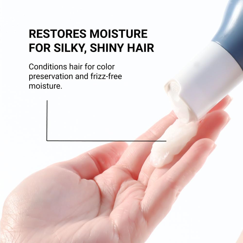 Hand applying Loma treatment to hair demonstrating easy spread