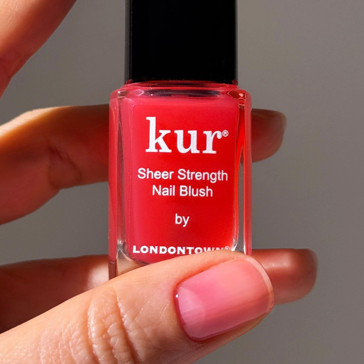 LONDONTOWN brush and bottle close-up displaying applicator for precise application