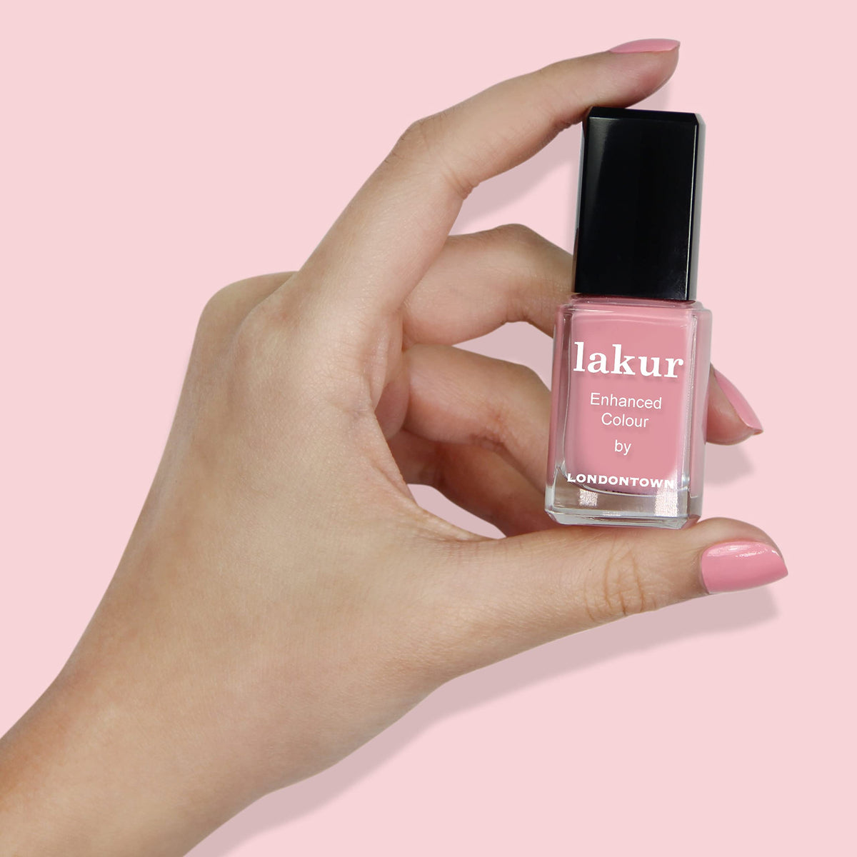 LONDONTOWN Desert Flower bottle next to a coin showing compact 0.4 fl oz travel-friendly size